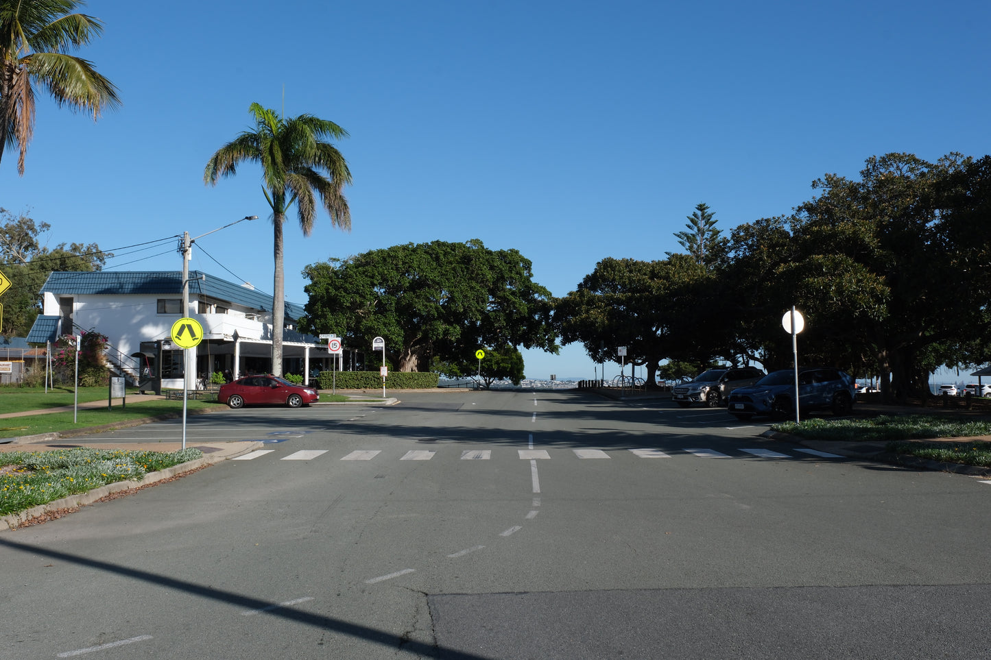 Looking back across Wellington Point with Oxley's and the ice cream shop building in view in Autumn in the Redlands